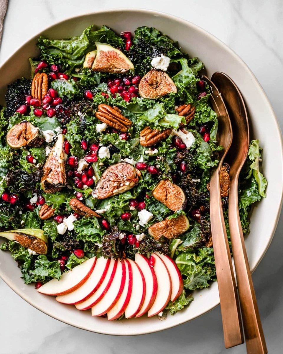 A white bowl sits on a white marbled surface, filled with a fresh salad layered with dark green kale and lighter green lettuce leaves at the base. Among the greens are scattered ruby red pomegranate seeds, light brown pecans, and small white crumbles of cheese. Small chunks of golden brown figs are spread evenly across the salad, while on one side a fan of thinly sliced red apple adds a pop of bright red and white color. Two bronze-colored salad servers rest inside the bowl on the right side. photo taken with an iphone --ar 4:5 --v 7