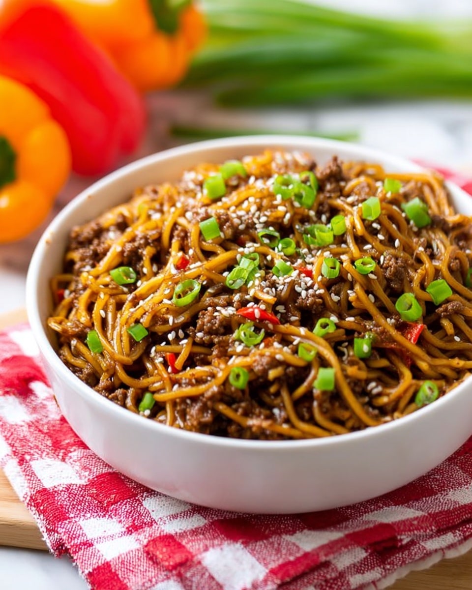 A white bowl is full of cooked noodles mixed with small pieces of browned meat and thin strips of red bell pepper, all coated in a glossy brown sauce. On top of the dish, there are white sesame seeds and chopped green onions scattered evenly. The bowl is set on a red and white checkered cloth on a white marbled surface. Next to the bowl, a whole red bell pepper lies on the cloth near the top right, and three fresh green onions rest near the bottom edge. There is also a wooden spoon with some sesame seeds placed in the top left corner. photo taken with an iphone --ar 4:5 --v 7