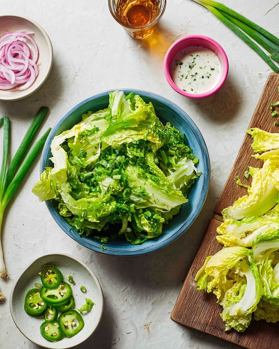 A blue bowl filled with layers of green lettuce leaves and fresh green herbs is placed near the center on a white marbled surface. To the right, a wooden board holds more pale yellow-green lettuce leaves spread out. Around the bowl, there are small white bowls, one with thinly sliced red onions soaking in liquid, another with sliced green onions in creamy white sauce, and a pink bowl with green sliced jalapeños. Bright green scallion stalks cross diagonally at the top, and a glass with a brown liquid sits near them. Photo taken with an iphone --ar 4:5 --v 7