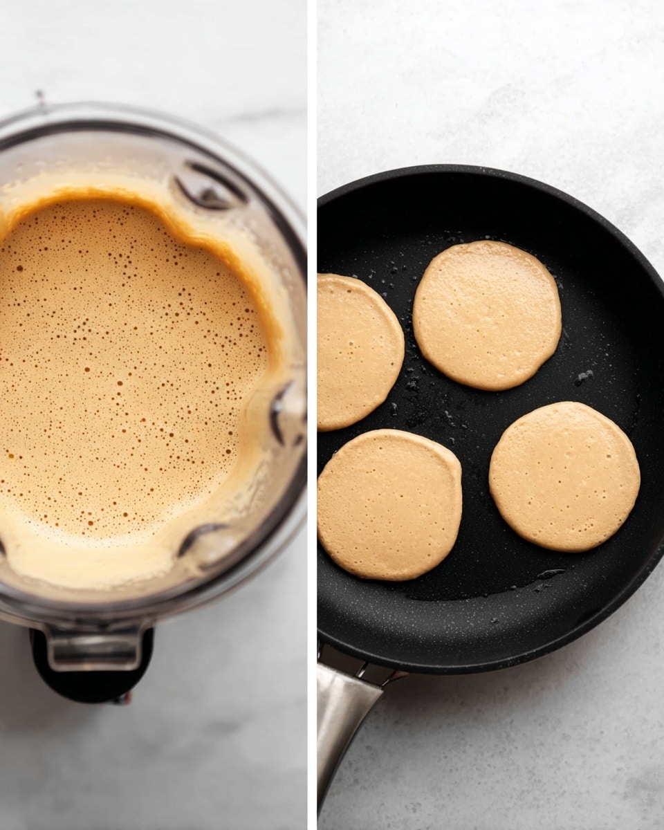 On the left, there is a close-up of a blender filled with a smooth, tan-colored batter that has tiny bubbles on the surface. On the right, a black frying pan with a slight sheen from cooking grease holds four small, round, light beige pancake batter blobs evenly spaced, set against a white marbled surface. The frying pan handle is visible at the bottom, and the batter circles have a soft, thick texture with slightly uneven edges. photo taken with an iphone --ar 4:5 --v 7