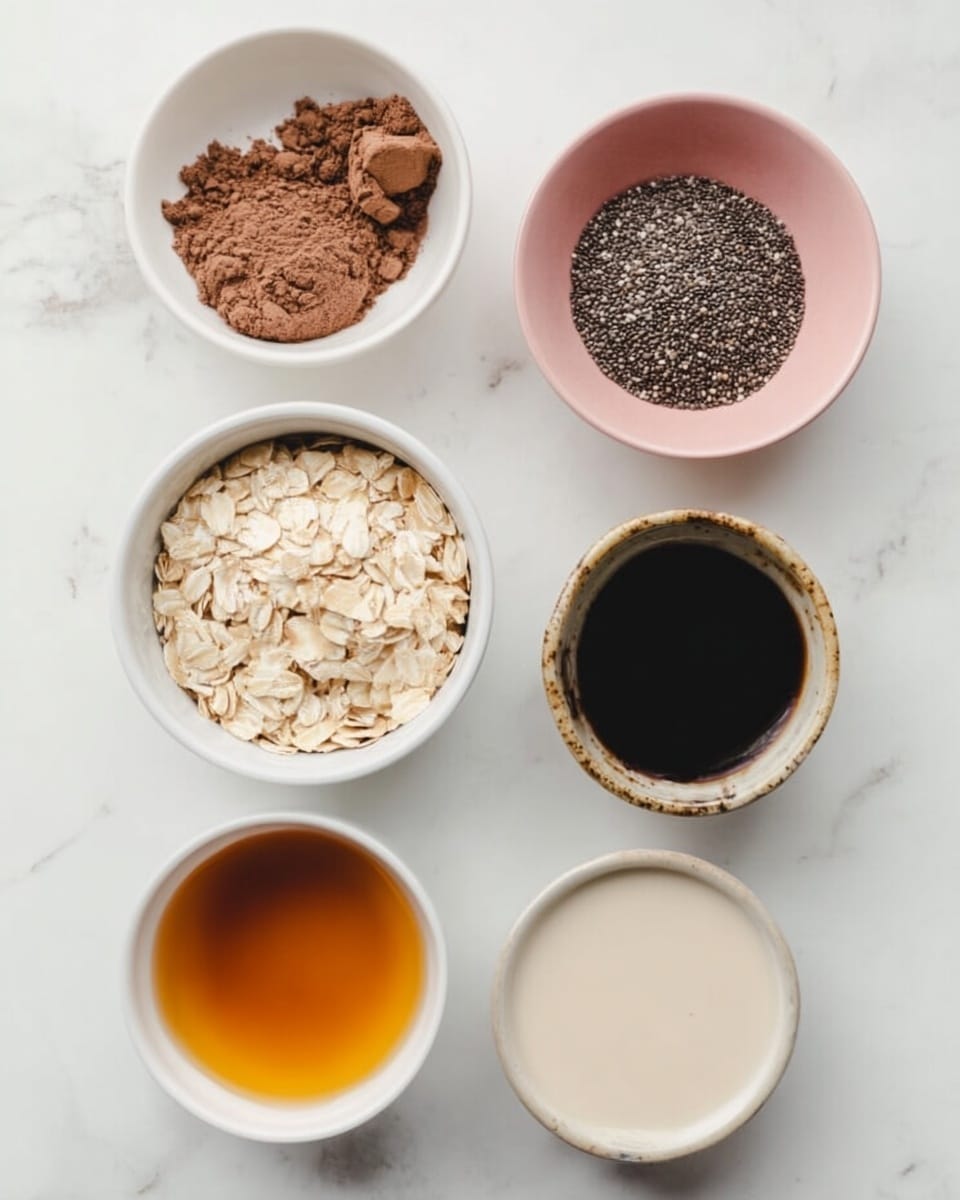 The image shows seven small white bowls arranged on a white marbled surface, each containing different ingredients. Starting from the top left, there is a bowl with brown powder and a darker brown scoop of powder on top. To the right, a bowl holds small black and white seeds, likely chia seeds. Next, a pink bowl contains pale, flat rolled oats. Below them, from left to right, there is a bowl with golden liquid, a smaller bowl with dark amber liquid, a bowl with black coffee that has a frothy surface, and finally, a bowl filled with light cream-colored liquid. The arrangement is neat and the colors range from dark browns and blacks to light creams and pale oats, creating a balanced visual. photo taken with an iphone --ar 4:5 --v 7