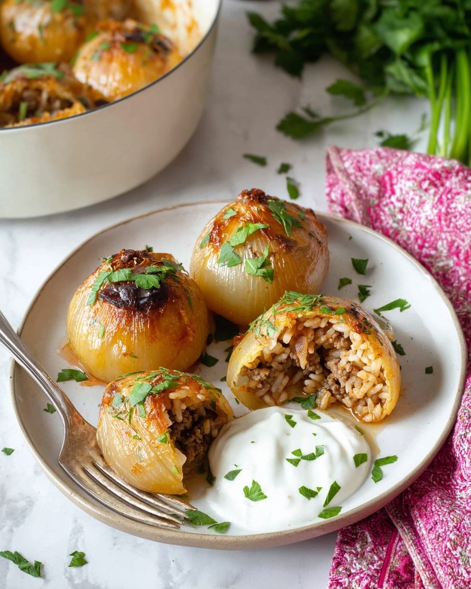 A white plate holds four stuffed, golden-brown roasted onions garnished with chopped green herbs. One onion is open, revealing a filling of cooked rice mixed with ground meat and herbs, showing layers of light brown rice and darker meat inside. Next to the onions on the plate is a dollop of white creamy sauce topped with some green herbs. A silver fork rests on the plate’s edge near the sauce. In the background, part of a white pot with more stuffed onions is visible, along with a green herb sprig and a pink patterned cloth, all set on a white marbled surface. photo taken with an iphone --ar 4:5 --v 7