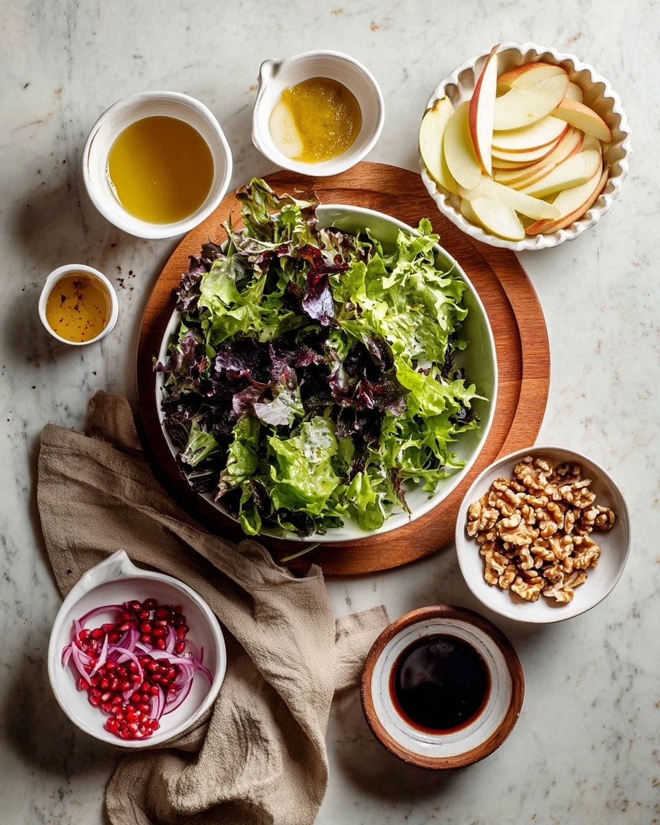 A large white bowl filled with mixed green salad leaves in different shades of green and some dark purple, placed on a round wooden board; above it, a bowl with thin white and yellow apple slices, next to the bowl are three small white cups containing light brown mustard, golden honey, and an empty cup with some mustard residue; to the right, a white scalloped bowl filled with chopped walnuts; below the salad bowl, a small white bowl with bright red pomegranate seeds, a tiny bowl with several slices of red onion, and another small white bowl filled with dark balsamic vinegar; a beige cloth is placed under the pomegranate bowl on a white marbled surface photo taken with an iphone --ar 4:5 --v 7