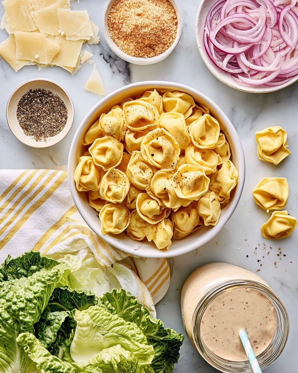 A top view of a white bowl filled with yellow tortellini pasta, with some tortellini pieces scattered on a white marbled surface around it. To the top right, a small white bowl holds thin slices of red onions with a pinkish-purple hue. Nearby, another small white bowl contains light brown breadcrumbs, with a small pile spilled beside it. To the left, pale yellow shaved cheese pieces lie next to a small beige bowl of cracked black pepper. At the bottom, fresh green romaine lettuce leaves partly rest on a white cloth with yellow stripes. A clear glass jar filled with a creamy beige dressing topped with black pepper and a white straw is positioned at the lower right. All items are laid out neatly on a white marbled surface. Photo taken with an iphone --ar 4:5 --v 7