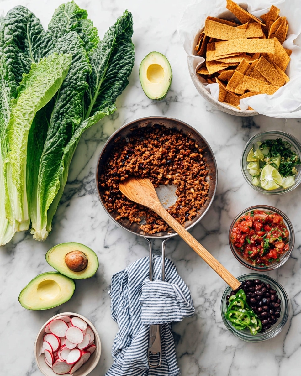 The image shows a cooking scene arranged on a white marbled surface with various fresh ingredients and a pan. In the center is a metal pan filled with cooked finely chopped brown mixture, with a wooden spatula resting inside it. Around the pan, there is a bunch of fresh dark green romaine leaves on the left, two avocado halves showing light green flesh and a brown seed on top, and a round white bowl filled with thin radish slices. To the right, a white bowl lined with white paper holds golden brown crispy tortilla strips. Nearby, two small glass bowls contain a red tomato-based salsa with green herbs, and another green sauce. Below, two more glass bowls show black and brown beans and sliced dark green peppers. A folded blue and white striped linen rests under the pan handle, completing the fresh and colorful cooking setup photo taken with an iphone --ar 4:5 --v 7