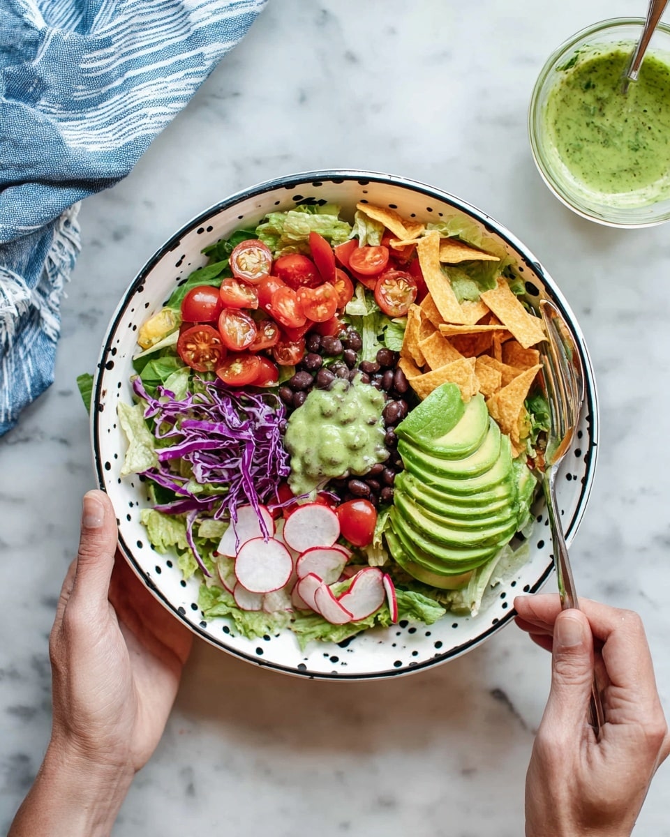 A white bowl with brown dots around the edge contains a layered salad starting with chopped green lettuce at the base, topped with slices of bright red cherry tomatoes, thin slices of green jalapeño, and thin radish rounds. Purple shredded cabbage and black beans add more color on one side. There are crispy light brown strips scattered on top, with a mound of green guacamole placed near the center. Sliced avocado fanned out sits prominently near the top center, next to a small pile of diced red tomatoes. A woman's hand holds the bowl from the bottom left while another woman's hand holds a fork near the right side of the bowl. The bowl sits on a white marbled surface photo taken with an iphone --ar 4:5 --v 7