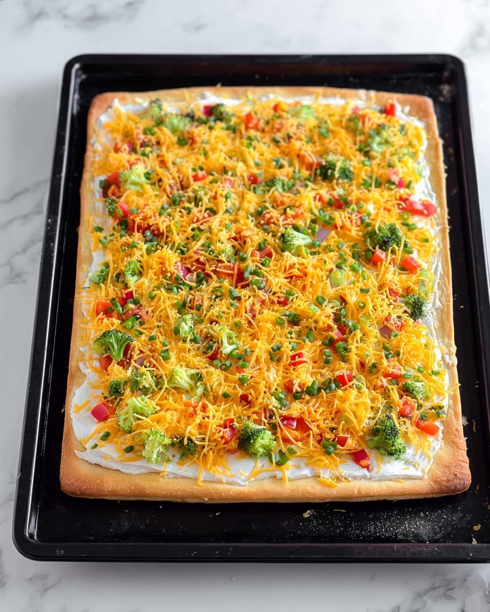 A square pizza with a golden-brown crust forms the base layer, resting on a black baking tray. The first layer on top of the crust is smooth and white, spread evenly across the surface. Over this, a bright, colorful mix of finely chopped green broccoli, red and yellow bell peppers, and green onions are scattered thickly. A generous amount of shredded orange cheddar cheese covers the vegetables, creating a vibrant and textured top layer. The black baking tray contrasts with the bright colors, all set on a white marbled surface. Photo taken with an iphone --ar 4:5 --v 7