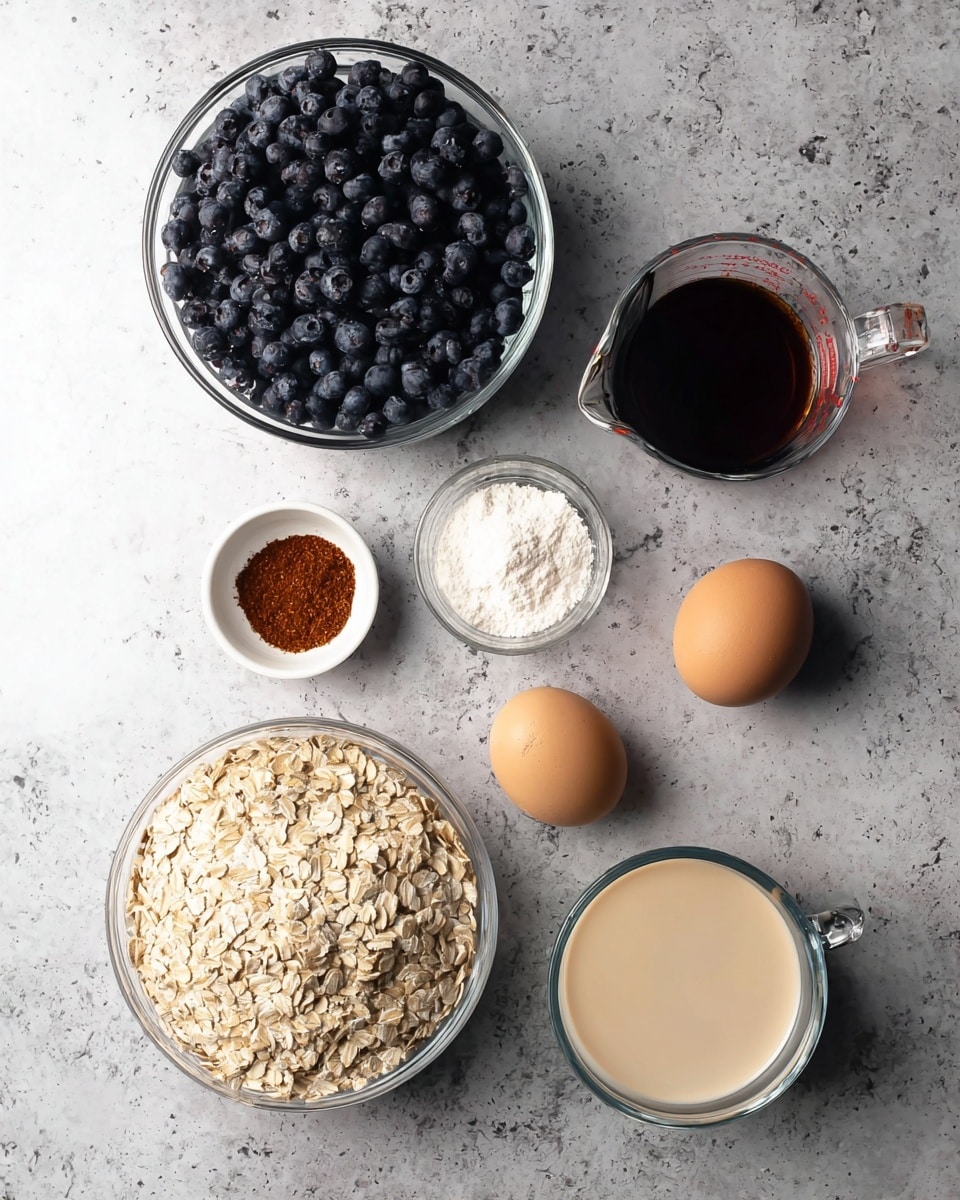 A top view of various ingredients placed on a white marbled surface. There is one large clear glass bowl filled with fresh dark blue blueberries at the top left. Next to it on the right is a small clear glass measuring cup filled with dark brown liquid, and below that a small white bowl with sifted white powder. Toward the center, a small white bowl contains a heap of reddish-brown spice. To the left, there are two brown eggs resting directly on the surface. At the bottom left is a large clear glass bowl filled with light tan rolled oats. To the right of the oats is a clear measuring cup filled with creamy light beige liquid. All items are spaced evenly with no overlapping. photo taken with an iphone --ar 4:5 --v 7