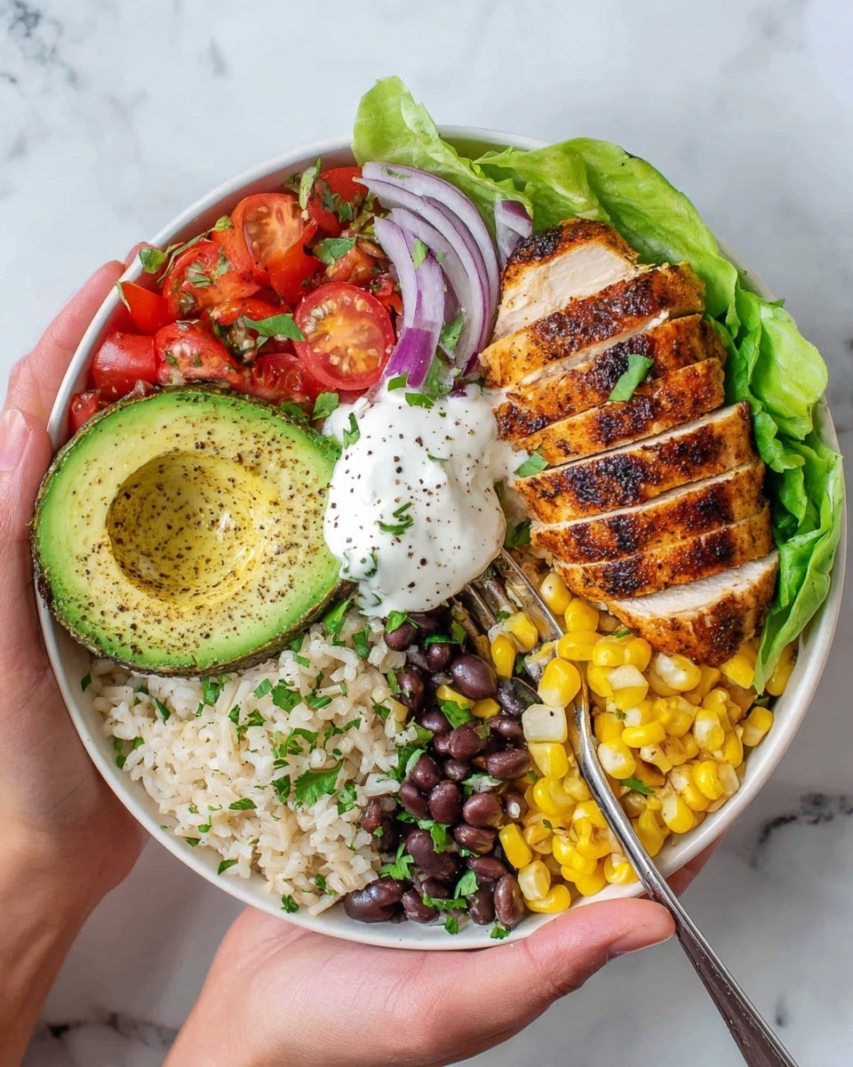 A white bowl filled with layers of food arranged in sections. On one side, there is a bed of green lettuce leaves. Next to it, several slices of grilled chicken with grill marks and a light golden brown color are placed. Beside the chicken, there is a portion of bright yellow corn kernels. Moving clockwise, there is white rice mixed with chopped green herbs. On top of the rice, two slices of green avocado sit stacked with a dollop of white sour cream sprinkled with black pepper. Next to the avocado, there are chopped red tomatoes mixed with green peppers, and beside them, a small section of black beans. The bowl is set on a white marbled surface. Photo taken with an iphone --ar 4:5 --v 7