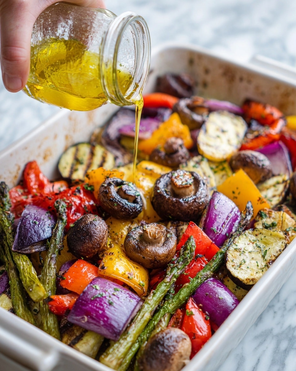 The image shows a close-up of a white dish filled with various roasted vegetables. The bottom layer has grilled slices of purple eggplant and green asparagus, showing char marks and a slightly wrinkled texture. Above that are chunks of red and yellow bell peppers with a glossy, slightly burnt skin. Scattered among the peppers are pieces of red onion with a deep purple color and softened texture. On top of everything are small brown mushrooms with a glossy surface, some showing herbs sprinkled on them. A woman's hand is pouring golden oil from a glass jar over the vegetables, creating a shiny coating. The background is a white marbled surface. photo taken with an iphone --ar 4:5 --v 7
